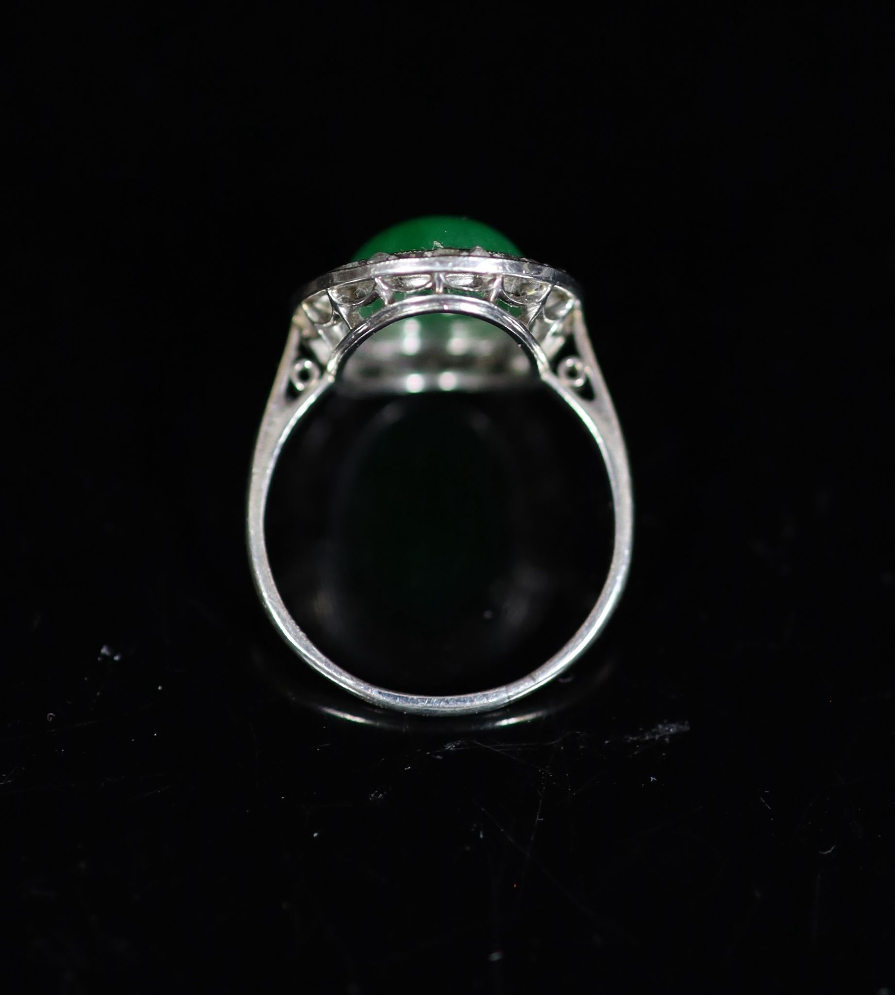 A 1920's 18ct white gold, oval cabochon jadeite and rose cut diamond millegrain set dress ring